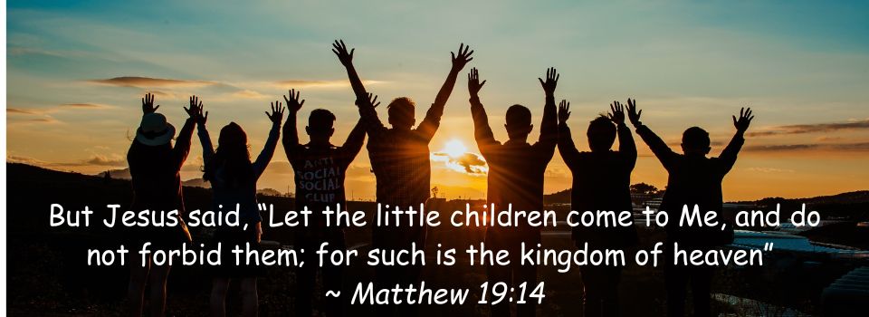 Image of children facing a sunrise in the distance with their hands raised in praise to God with written scripture of Matthew 19:14 underneath
