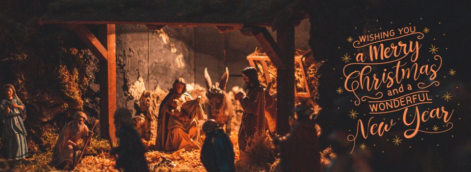 Image of a stable with animals and people surrounding the baby Jesus after his birth